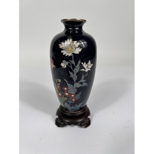 384A - A Chinese cloisonne with deep blue ground floral decoration silvered rim vase attached to hardwood s... 