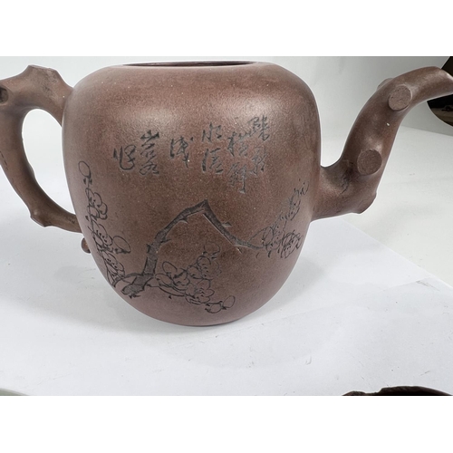 395 - A Chinese Yi-Xing teapot with incised blossom decoration and naturalistic handle and spout and lid a... 