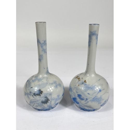 450 - A pair of Chinese pale blue and white  bottle vases, with bird decoration and character marks to bas... 