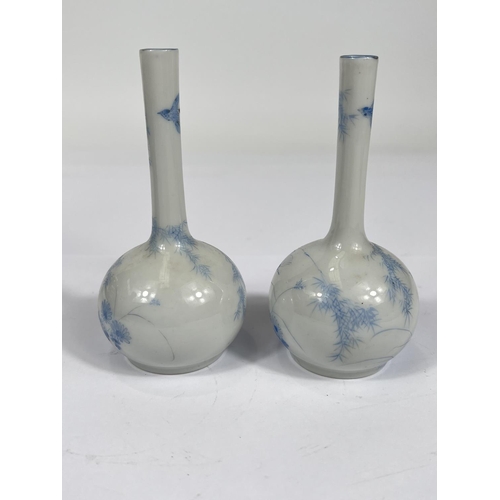 450 - A pair of Chinese pale blue and white  bottle vases, with bird decoration and character marks to bas... 