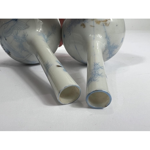 450 - A pair of Chinese pale blue and white  bottle vases, with bird decoration and character marks to bas... 