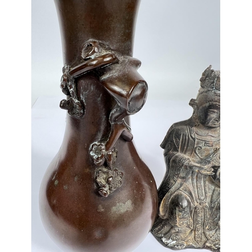 451 - A Chinese bronze of a seated buddha holding a mirror, height 16.5cm and a bronze vase