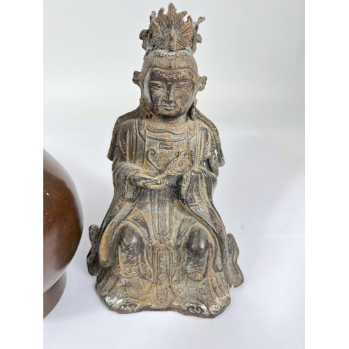 451 - A Chinese bronze of a seated buddha holding a mirror, height 16.5cm and a bronze vase