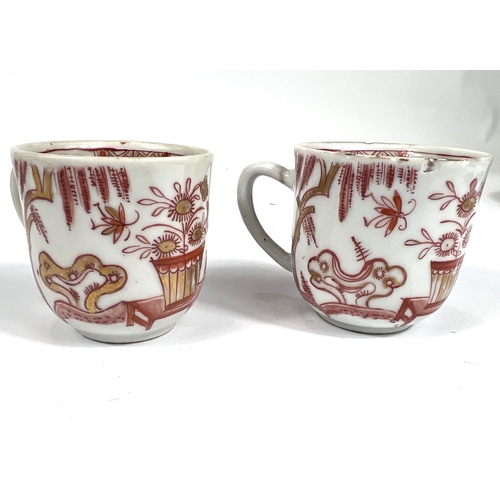 357A - A pair of Chinese 19th century tea cups with gilt and burnt orange decoration including internal dec... 