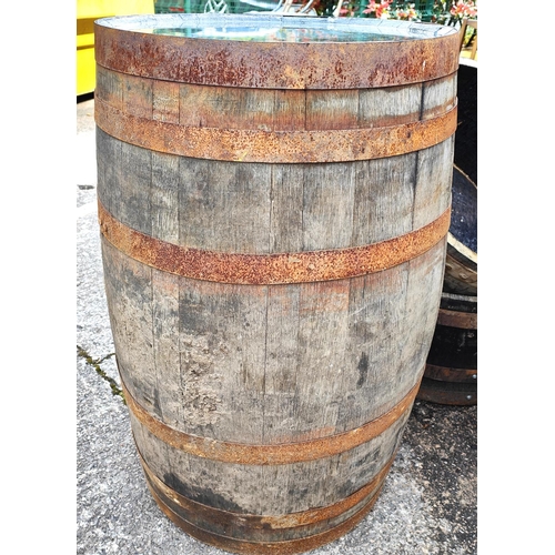 1000 - A full height metal bound wooden barrel, height 90cm