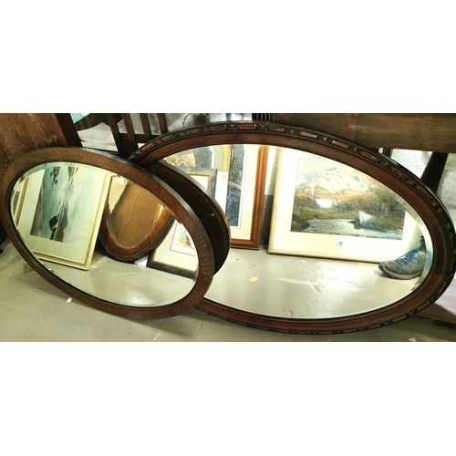 848 - Two bevelled edge wall mirrors in oval mahogany frames