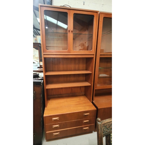 850A - A Gplan teak wall unit with glazed top cupboard over 2 shelves with 3 drawers below