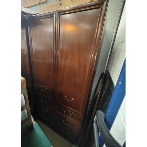 877 - A Gplan mahogany effectbedroom suite comprising 2 double wardrobes, 7 drawer chest and 5 drawer ches... 