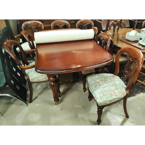 879 - A Victorian style mahogany dining suite comprising rounded rectangular extending table (with one lea... 