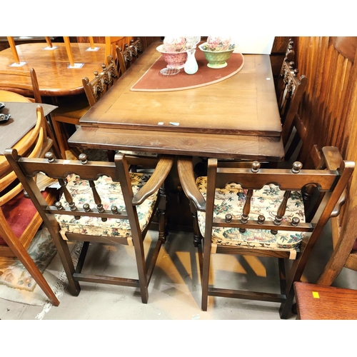 899 - An Ercol style dining suite in the Jacobean manner with draw leaf table and 6 (4 + 2) chairs with ar... 