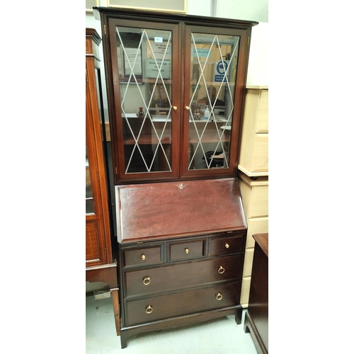 906 - A Stag display bureau bookcase with double glazed doors above, fall front with fitted interior three... 