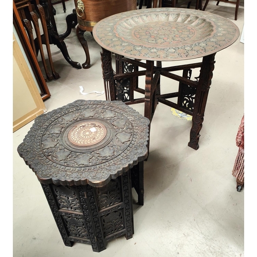 912 - A Middle Eastern occasional table with brass top, on folding base; a similar table