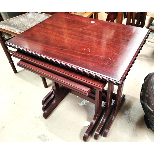 949 - A nest of 3 reproduction mahogany occasional tables; a folding light wood occasional table