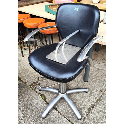 955 - A vintage leather effect and chrome barber's armchair with foot stand