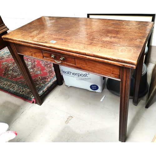 974 - A Georgian mahogany fold over 'T' table with frieze drawer and waive moulded legs