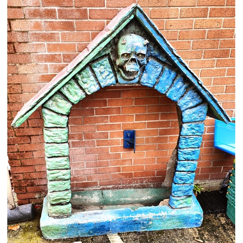 998 - A fibre glass 'haunted house' arched door way with skull above, height 175cm