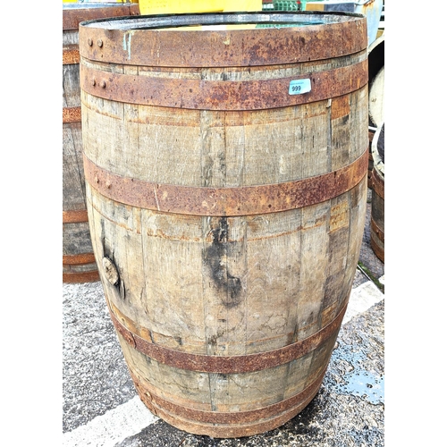 999 - A full height metal bound wooden barrel, height 90cm