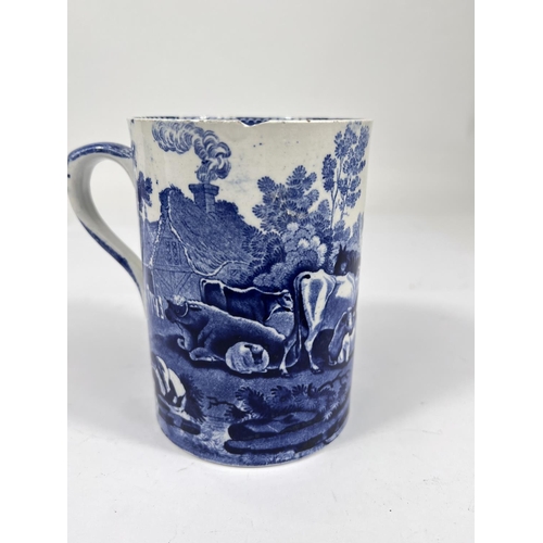 582 - A 19th century Adame blue and white mug decorated with cattle grazing (underglaze chip to rim)