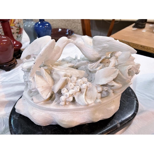 618 - A carved quartz depiction of birds on flowers on marble base