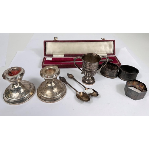 654 - A hallmarked silver pair of napkin rings; a hexagonal pair; a hallmarked silver small trophy cup; a ... 