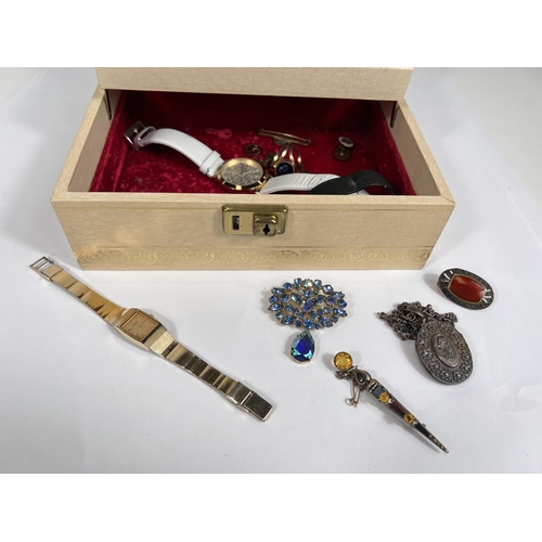 668 - A cantilevered jewellery box with costume jewellery and watches