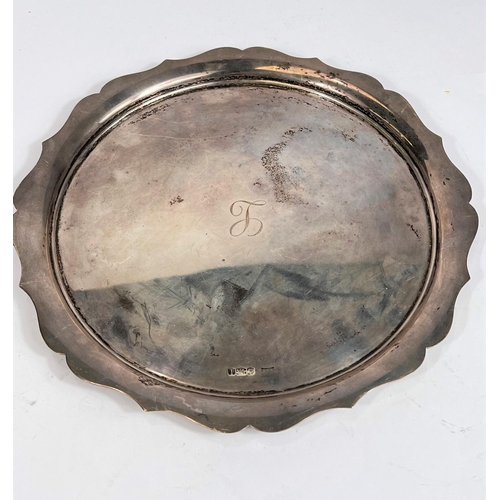 737A - A hallmarked silver circular salver with wavy border, Sheffield 16oz, diameter 26cm