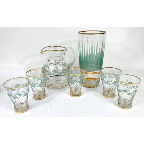 598 - A vintage lemonade set of 5 glasses and jug with gilt and green lesf decoration; a similar vase and ... 