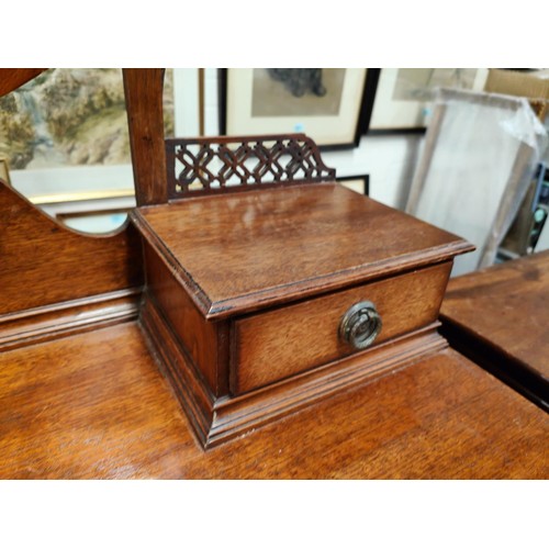 853 - An Arts & Crafts period kneehole mahogany dressing table with 2 drawers and 2 jewellery drawers ... 