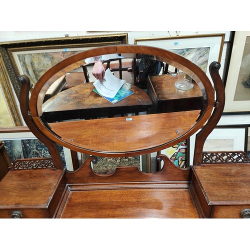 853 - An Arts & Crafts period kneehole mahogany dressing table with 2 drawers and 2 jewellery drawers ... 