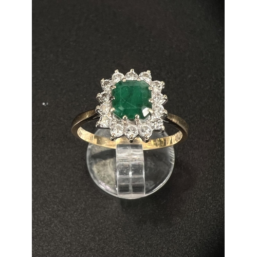 686 - An 18 carat hallmarked gold dress ring set square cushion cut emerald surrounded by 14 diamonds... 