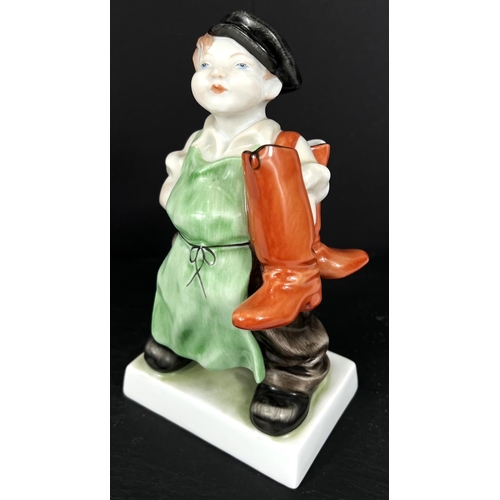 584B - A HEREND hand painted figure of a boy in cap with a pair of boots over his shoulder