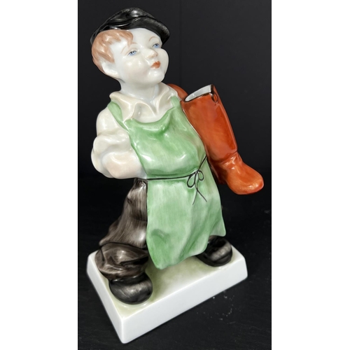 584B - A HEREND hand painted figure of a boy in cap with a pair of boots over his shoulder