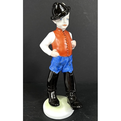 584C - A HEREND hand painted figure of a boy in cap with a feathered black cap, waistcoat and large black b... 