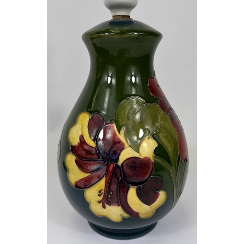 596 - A Moorcroft green ground table lamp, red and green Hibiscus flower decoration, height 19cm