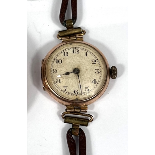 604 - A 9ct gold cased early 20th century wrist watch on a leather strap and a gold plated Elgin pocket wa... 