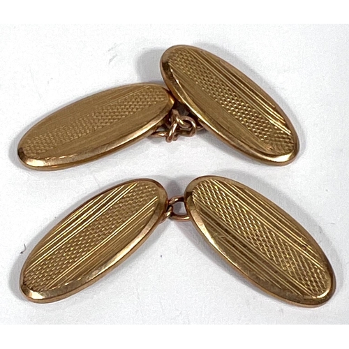 608 - A pair of 9ct gold engine turned cufflinks, 3.2gms.