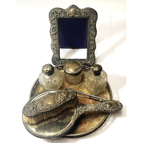 651 - A hallmarked silver picture frame (worn), hallmarked silver brush and mirror; 3 silver topped jars