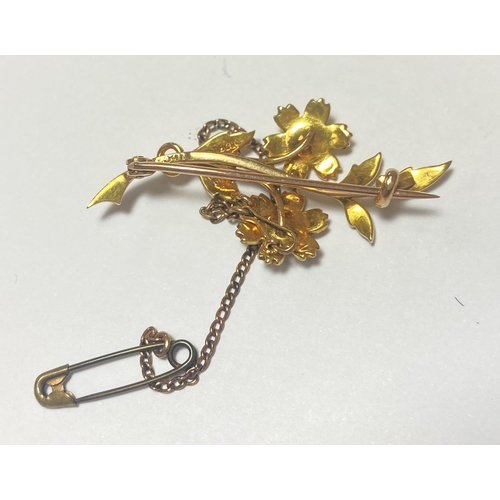 670 - A seed pearl set brooch in the form of flowers and leaves, stamped '18ct', 4.88gm