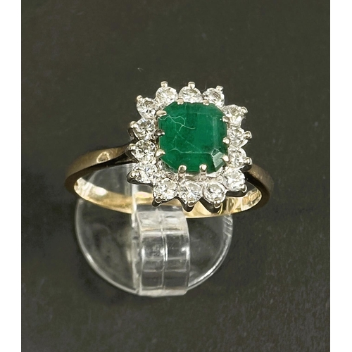 686 - An 18 carat hallmarked gold dress ring set square cushion cut emerald surrounded by 14 diamonds... 