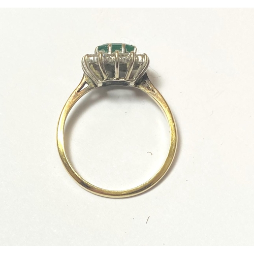 686 - An 18 carat hallmarked gold dress ring set square cushion cut emerald surrounded by 14 diamonds... 