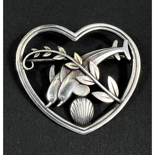 689 - George Jensen, a heart shaped openwork brooch with a pair of dolphins leaping above a shell, stamped... 