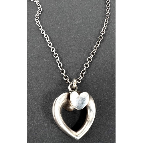 693 - Georg Jensen - an open heart shaped pendant with each side terminating at the top in a solid heart t... 