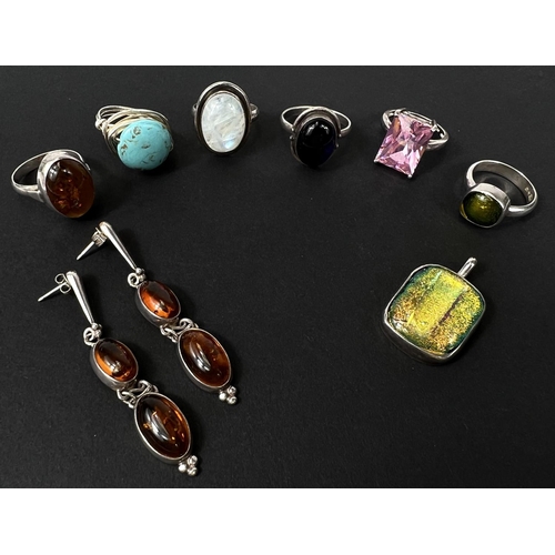 693C - Six silver rings set with a variety of stones including moonstone, turquoise, the amber ring with ma... 