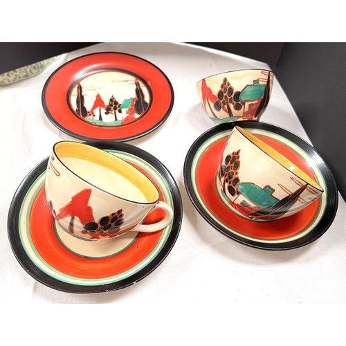574 - A pair of Clarice Cliff Fantasque 'House and Trees' cups and saucers, with rounded handles and bodie...