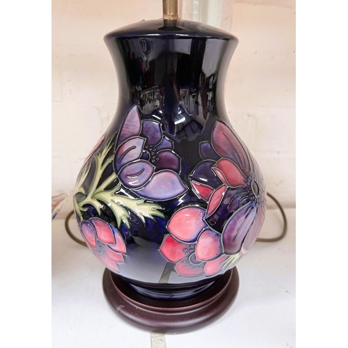 595A - A Moorcroft large, Clematis lamp with blue ground and wooden base, ht. 36cm