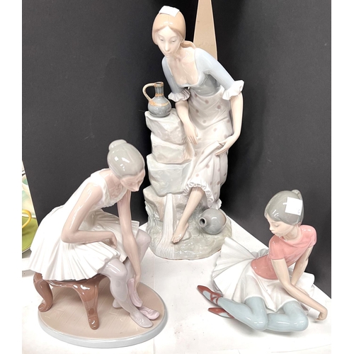 599C - A large Lladro style figure of a seated woman; a Lladro seated ballerina a similar Nao figure