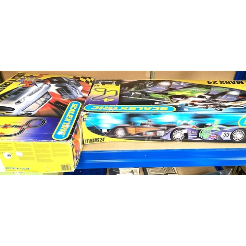 74 - SCALEXTRIC : 4 boxes, each with 2 cars