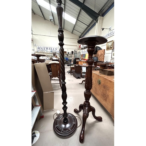 969 - A reproduction carved mahogany torchère on triple splay feet; a standard lamp with wooden rop... 