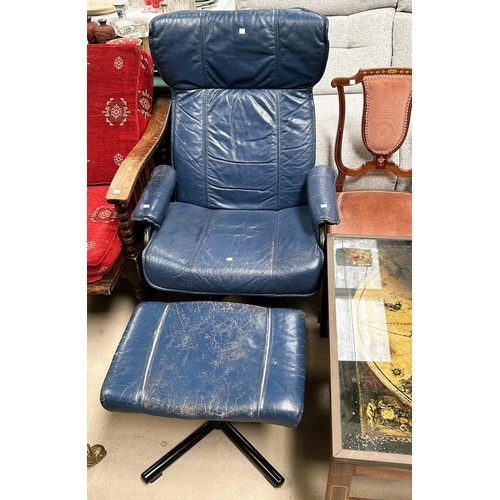 983 - A mid 20th century Danish easy chair in blue leather with footstool, label to base, black metal fram... 