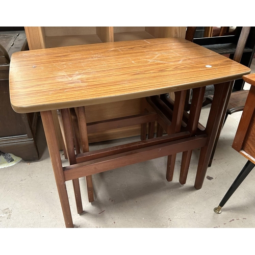 984 - A blue Lloyd Loom 2 tier occasional table; a mid 20th century veneered nest of tables